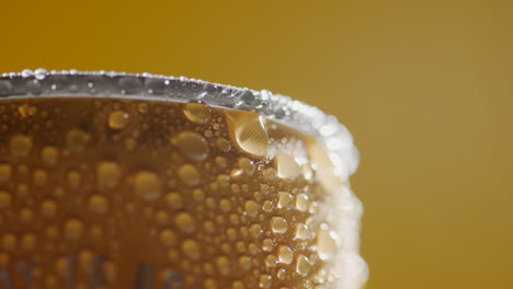 Close-Up-Of-Condensation-Droplets-On-Revolving-Takeaway-Can-Of-Cold-Beer-Or-Soft-Drink-Against-Yellow-Background-With-Copy-Space-2